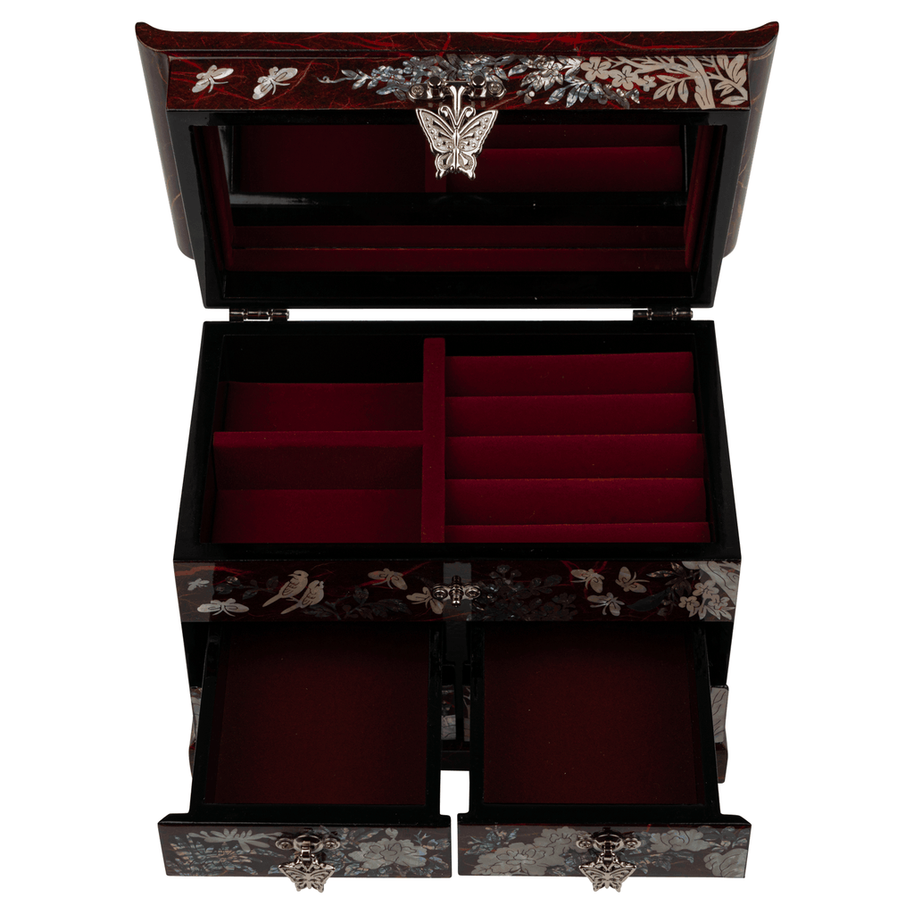 An open jewelry box revealing red velvet compartments and a mother-of-pearl lid.