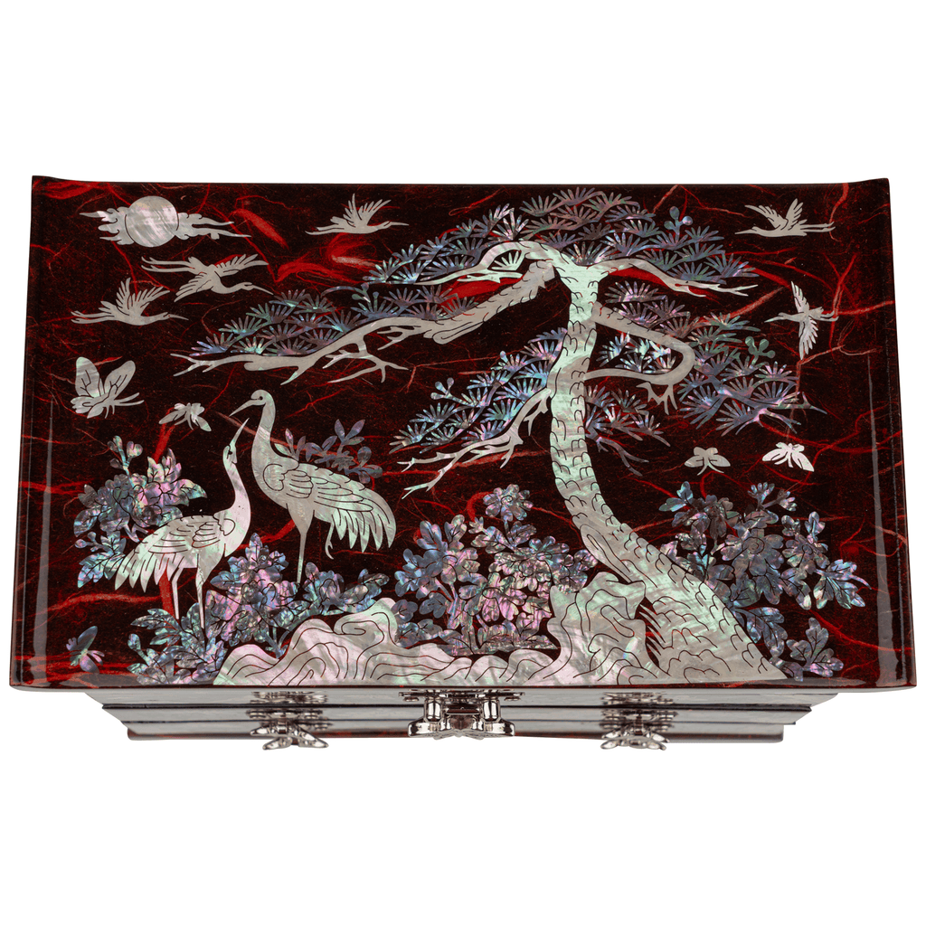 A red jewelry box with a crane and pine tree mother-of-pearl design.