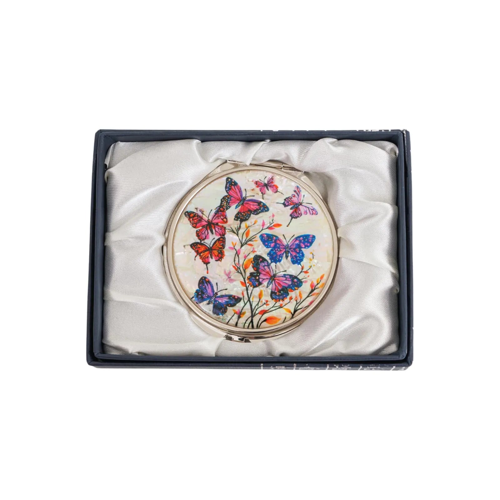 A round compact mirror with a vibrant design featuring colorful butterflies and delicate flowers, placed inside a white satin-lined box