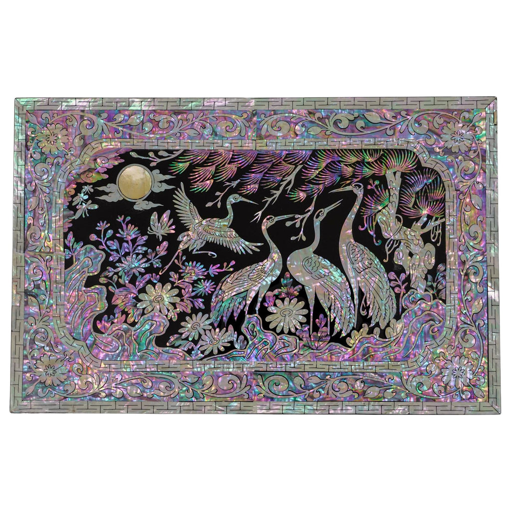 At the top of the jewelry box, a mother-of-pearl inlay showcases cranes under a moonlit sky surrounded by intricate foliage and framed by a detailed border.