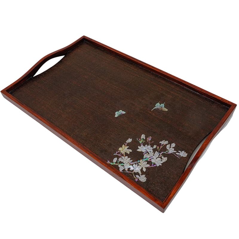 A wood-grained tray with mother-of-pearl butterflies and floral inlay, featuring a side handle.