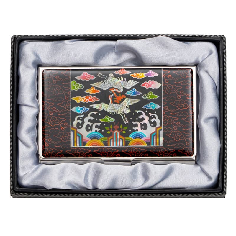 A mother of pearl business card holder featuring a traditional Korean crane design for good fortune, presented in a satin-lined gift box.