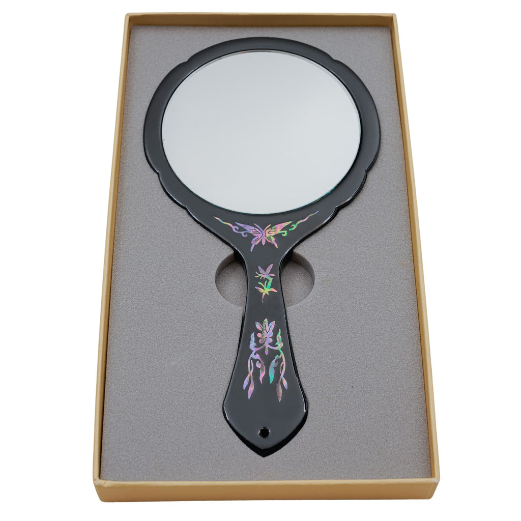 Black hand mirror with a plain reflective surface, decorated with mother-of-pearl inlay, in a foam-lined box.