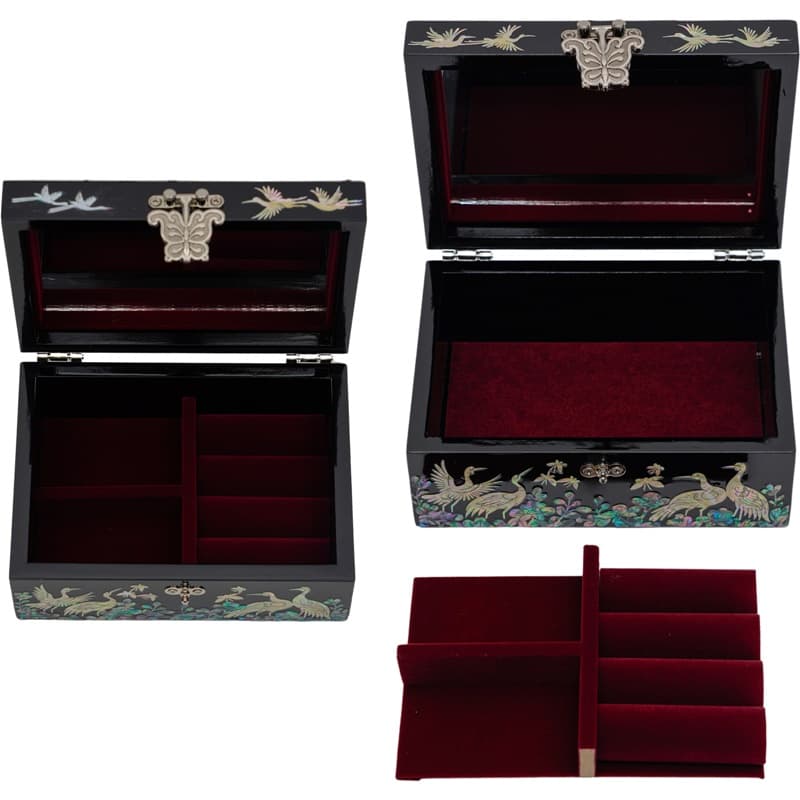 Black lacquer boxes with mother-of-pearl inlays open to reveal red velvet interiors; one with a removable tray, highlighting traditional Asian design elements.