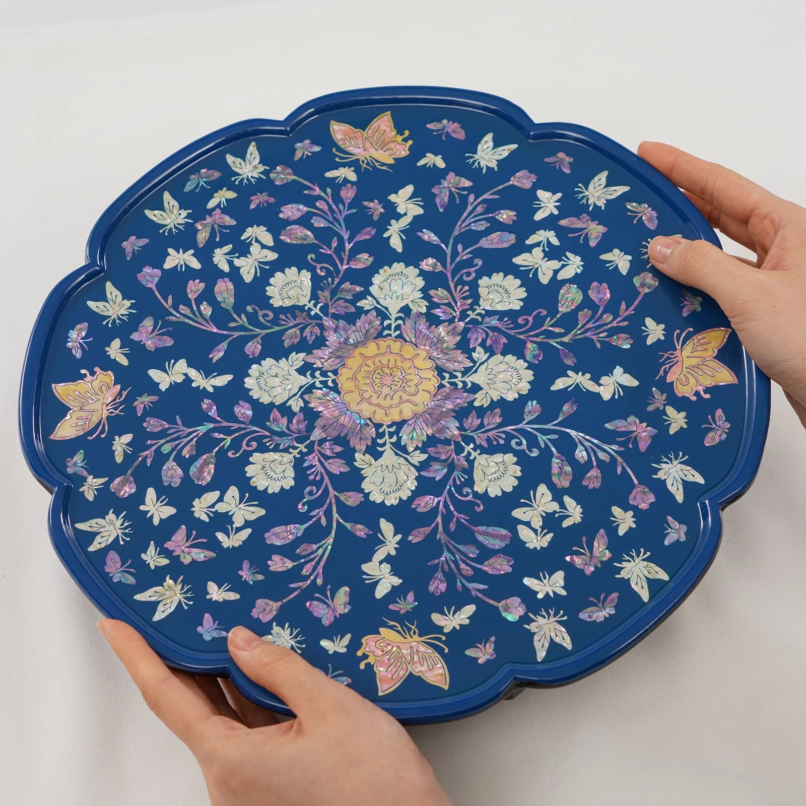 Blue mother of pearl inlay round tray table with butterfly and floral motif, scalloped edge and traditional lacquer art