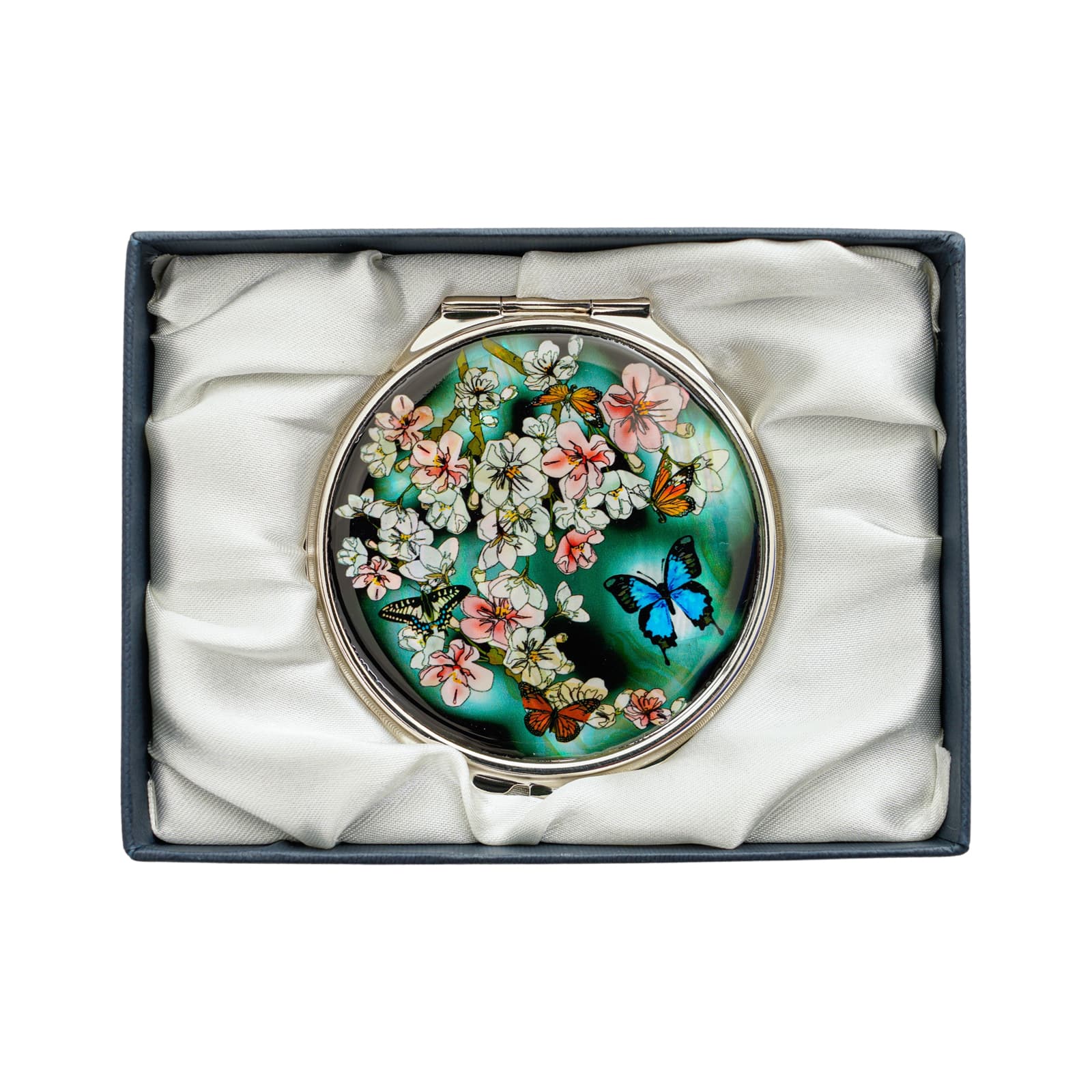 Compact mirror with blooming flowers and vibrant butterflies on a green background, in a satin gift box