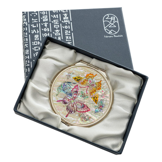 Elegant compact mirror featuring colorful butterfly designs on mother-of-pearl, in a premium gift box