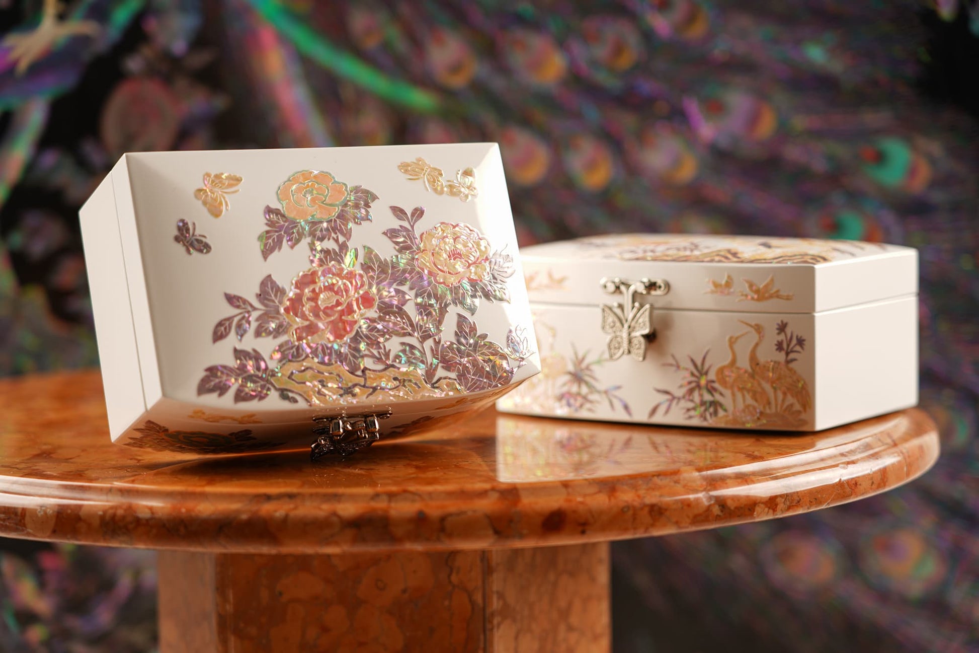 Floral inlay jewelry box with butterfly clasp, crane box in background