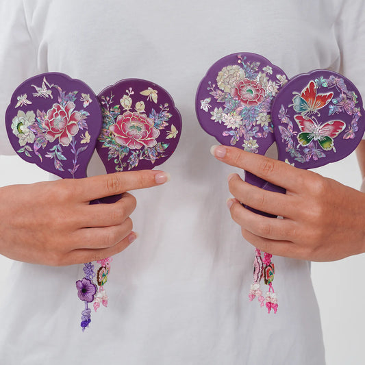 Four purple mother-of-pearl hand mirrors, each held with unique tassels