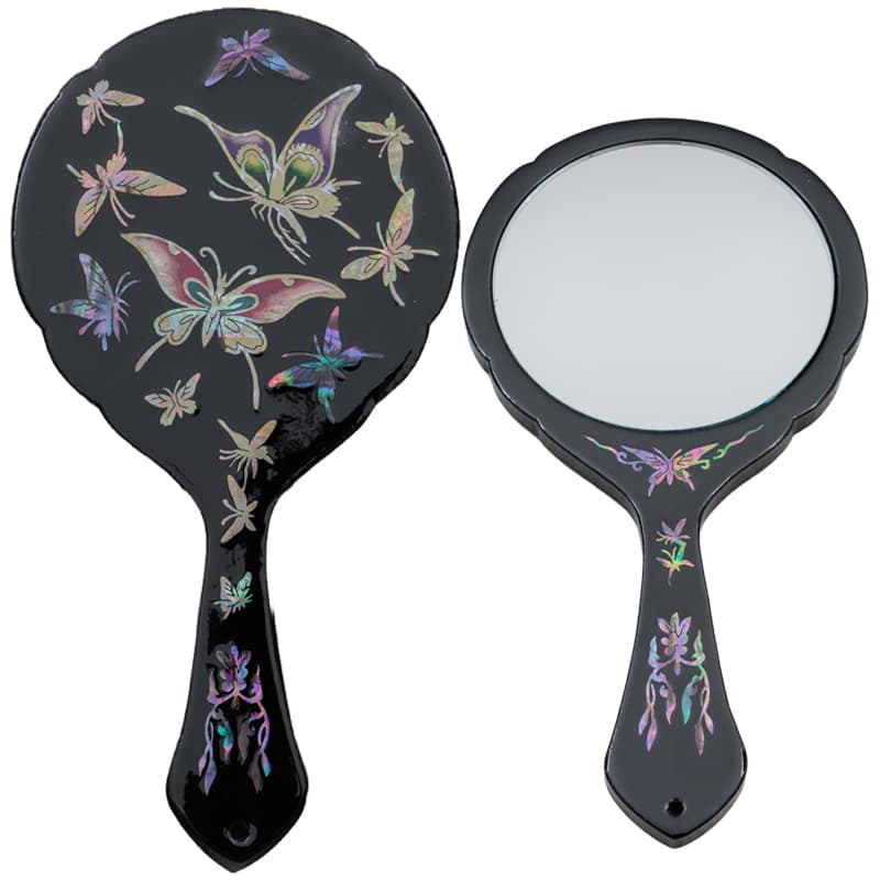 Front and back of a black hand mirror with mother-of-pearl inlay, showcasing colorful butterflies and floral accents.