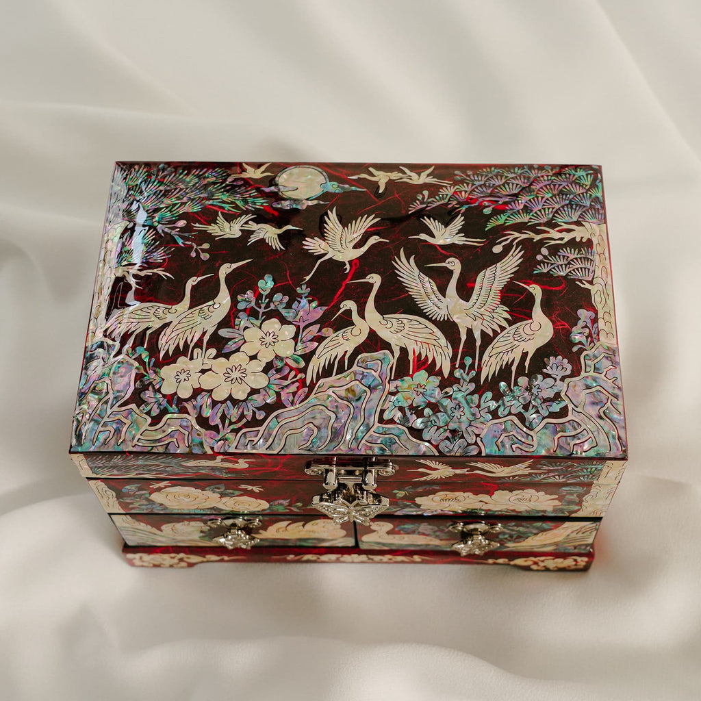 Korean jewelry box with crane design and pink flower décor background setting