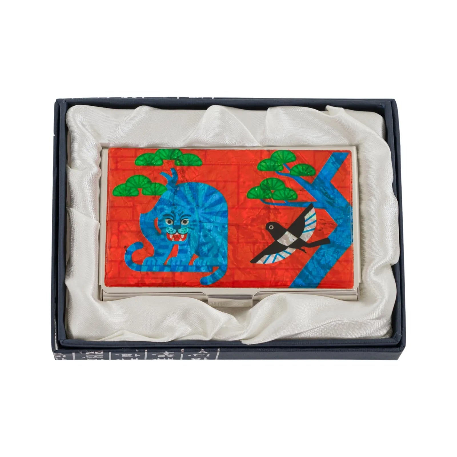Metal case with a blue tiger and bird design in a silk-lined gift box