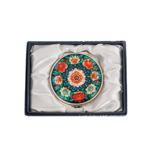 Mirror with bold flower pattern shown in silk-lined box