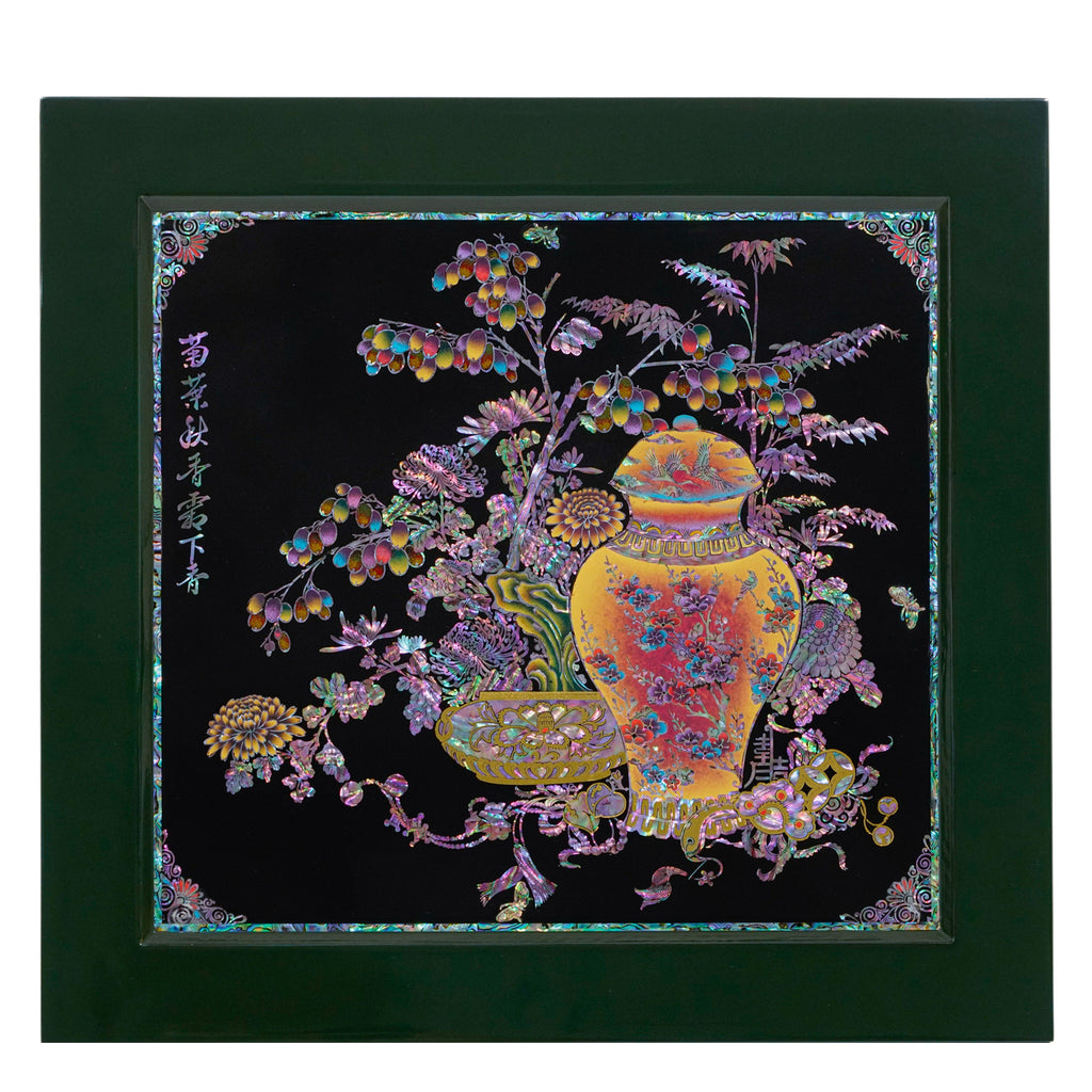 Korean mother of pearl artwork on a black background, framed by a deep green border. Features a vivid, ornate vase surrounded by vibrant flora and fruits. Branches laden with berries and blossoming flowers embellish the scene, radiating opulent colors.