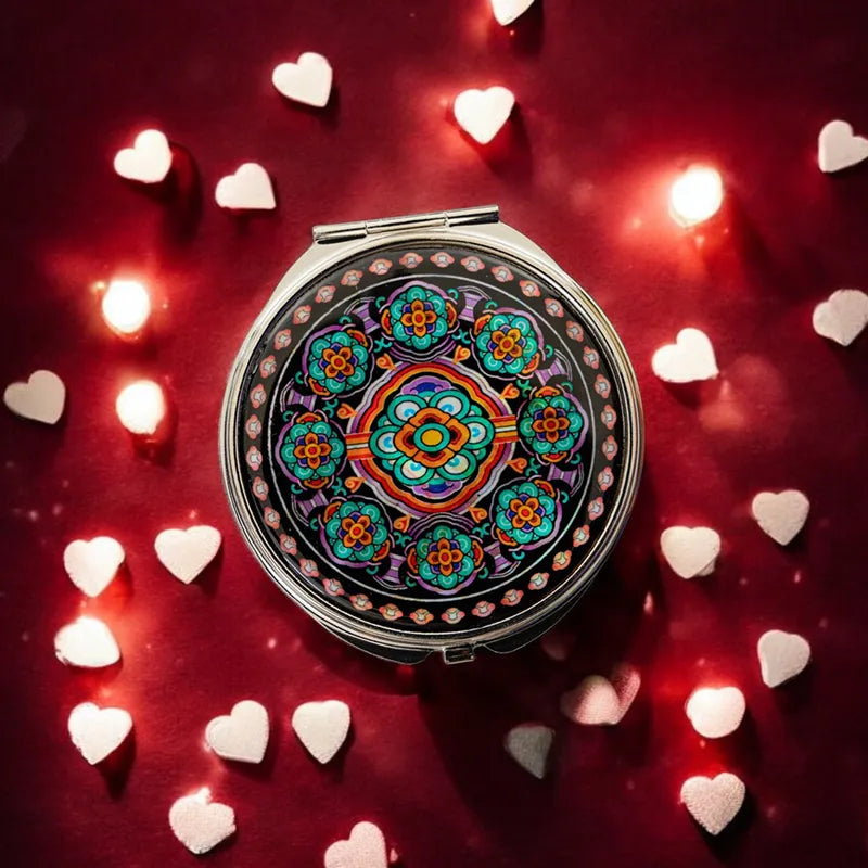 Mother-of-pearl compact mirror with a vibrant traditional Korean tile pattern, set against a romantic backdrop