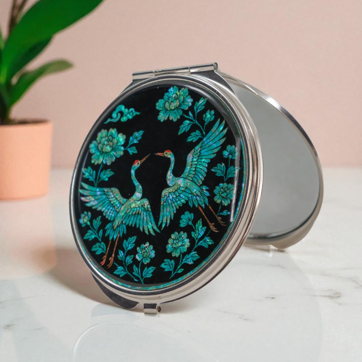 Mother-of-pearl compact mirror with cranes and floral pattern on black background