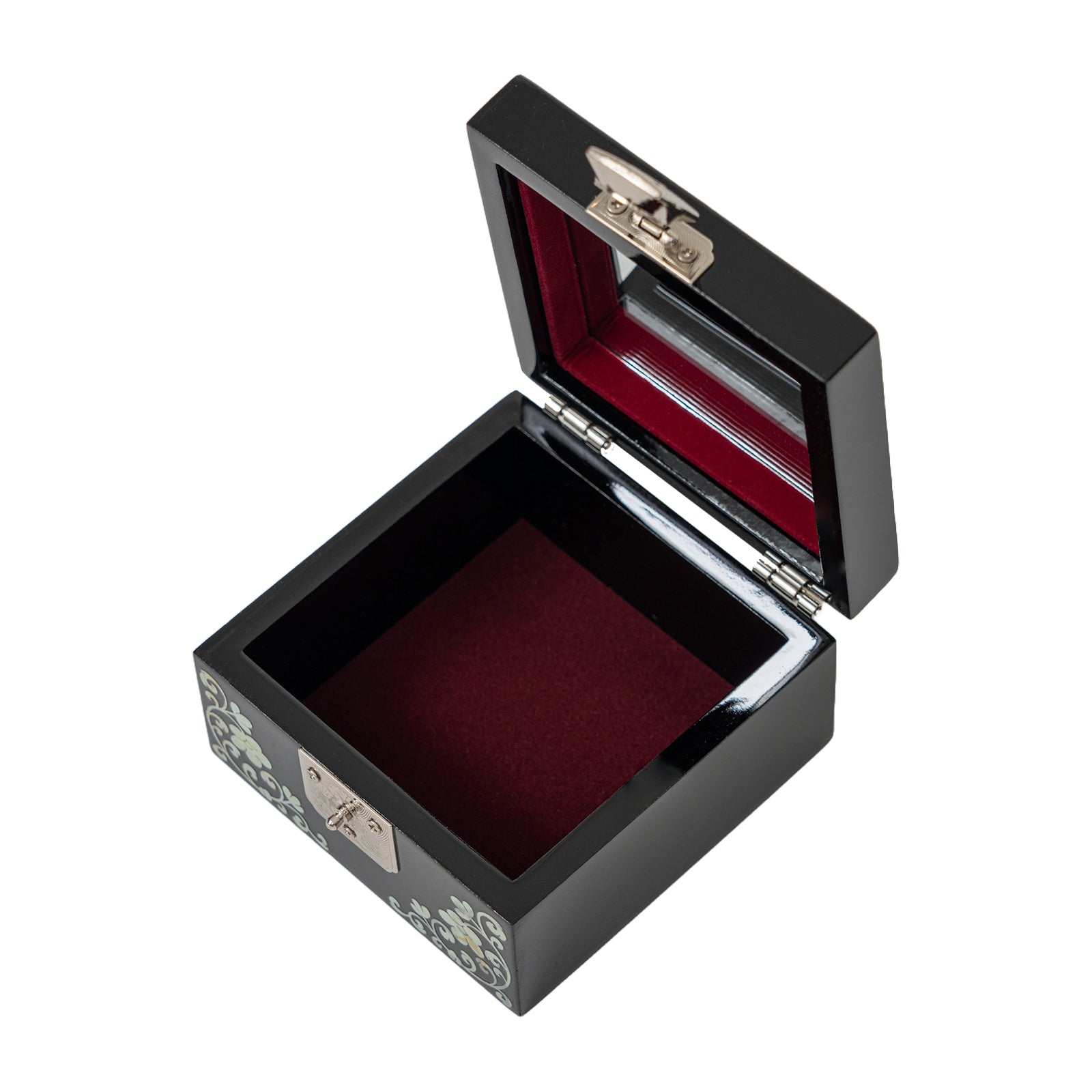 Open_black_mother-of-pearl_jewelry_box_with_a_deep_red_velvet_interior_and_a_silver_latch