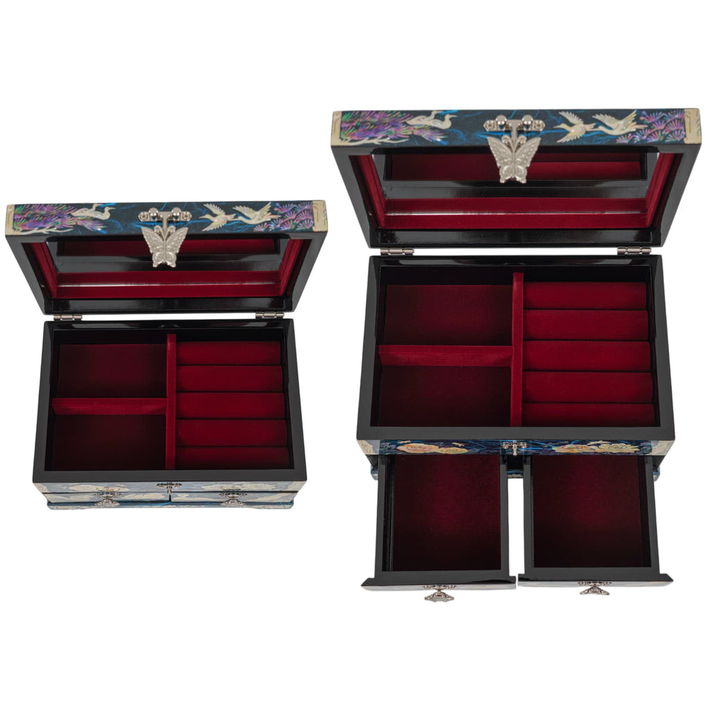 Open view of two jewelry boxes showing red velvet-lined compartments and ring holders
