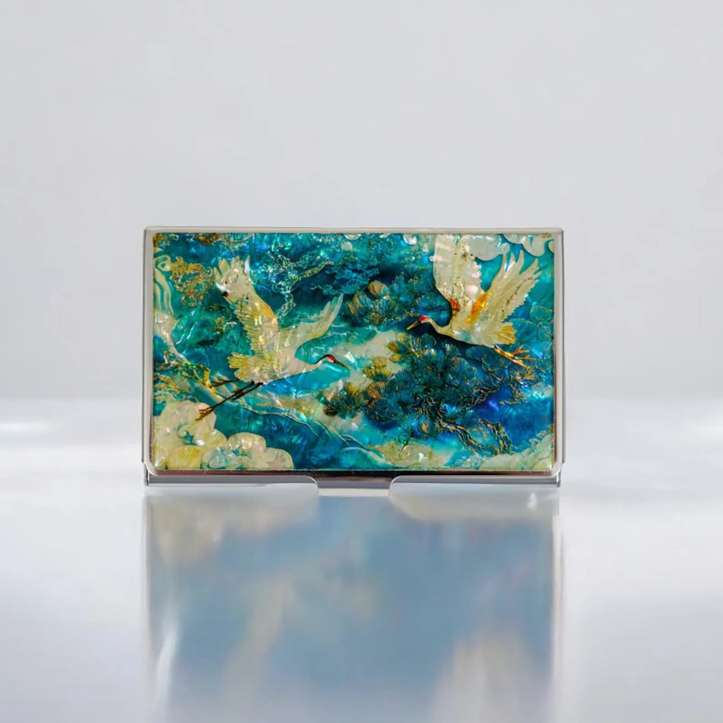 Rectangular card case with white cranes flying in blue and gold mother-of-pearl sky