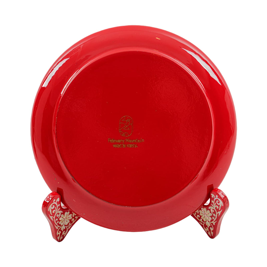 Red plate with a glossy finish, showing the back with a gold "February Mountain" logo and stand.