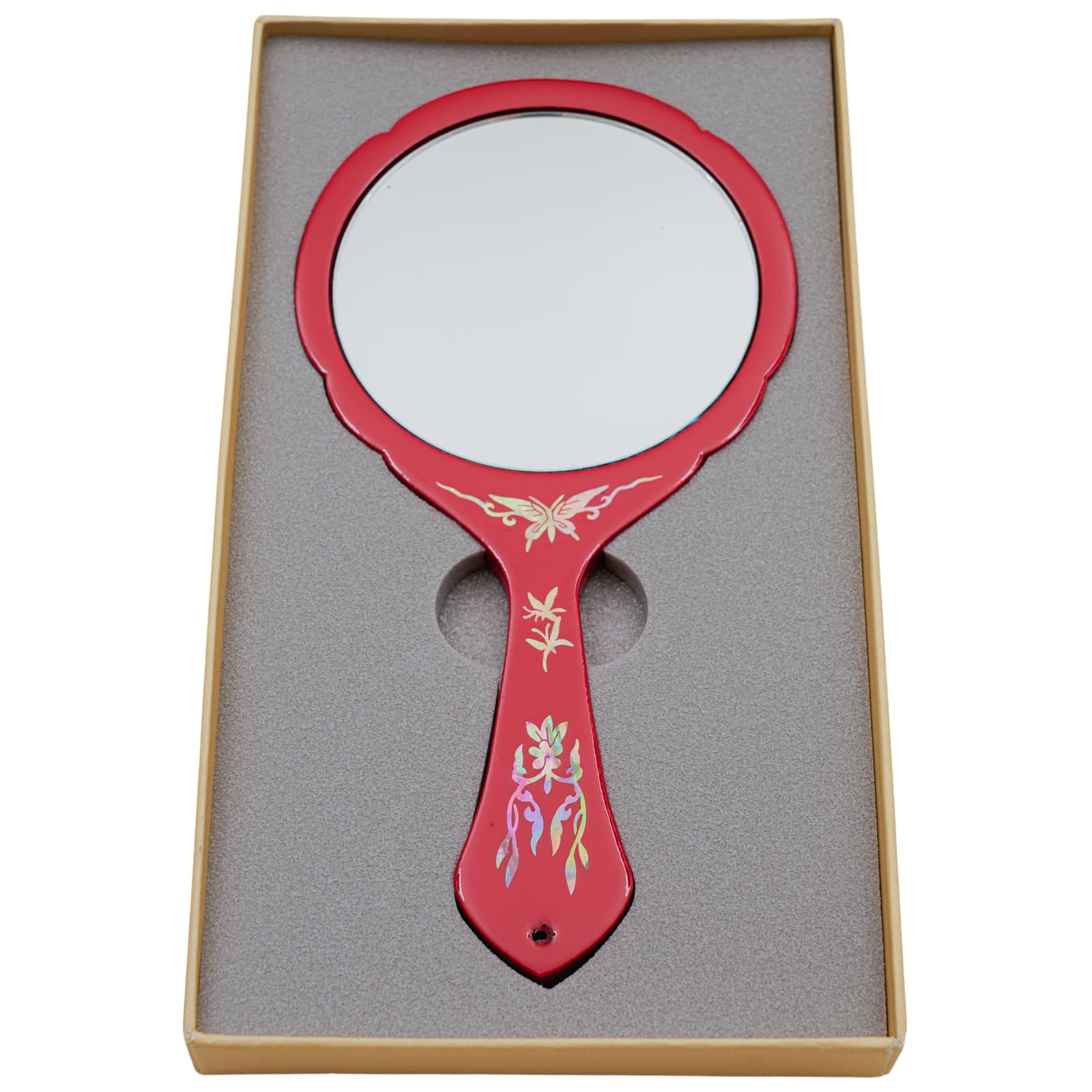 Red hand mirror with a plain reflective surface, decorated with mother-of-pearl inlay, in a foam-lined box.