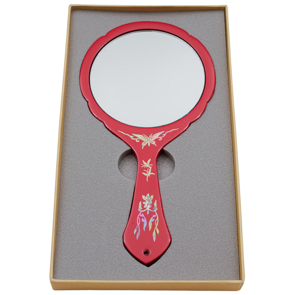 Red hand mirror with a plain reflective surface, decorated with mother-of-pearl inlay, in a foam-lined box.