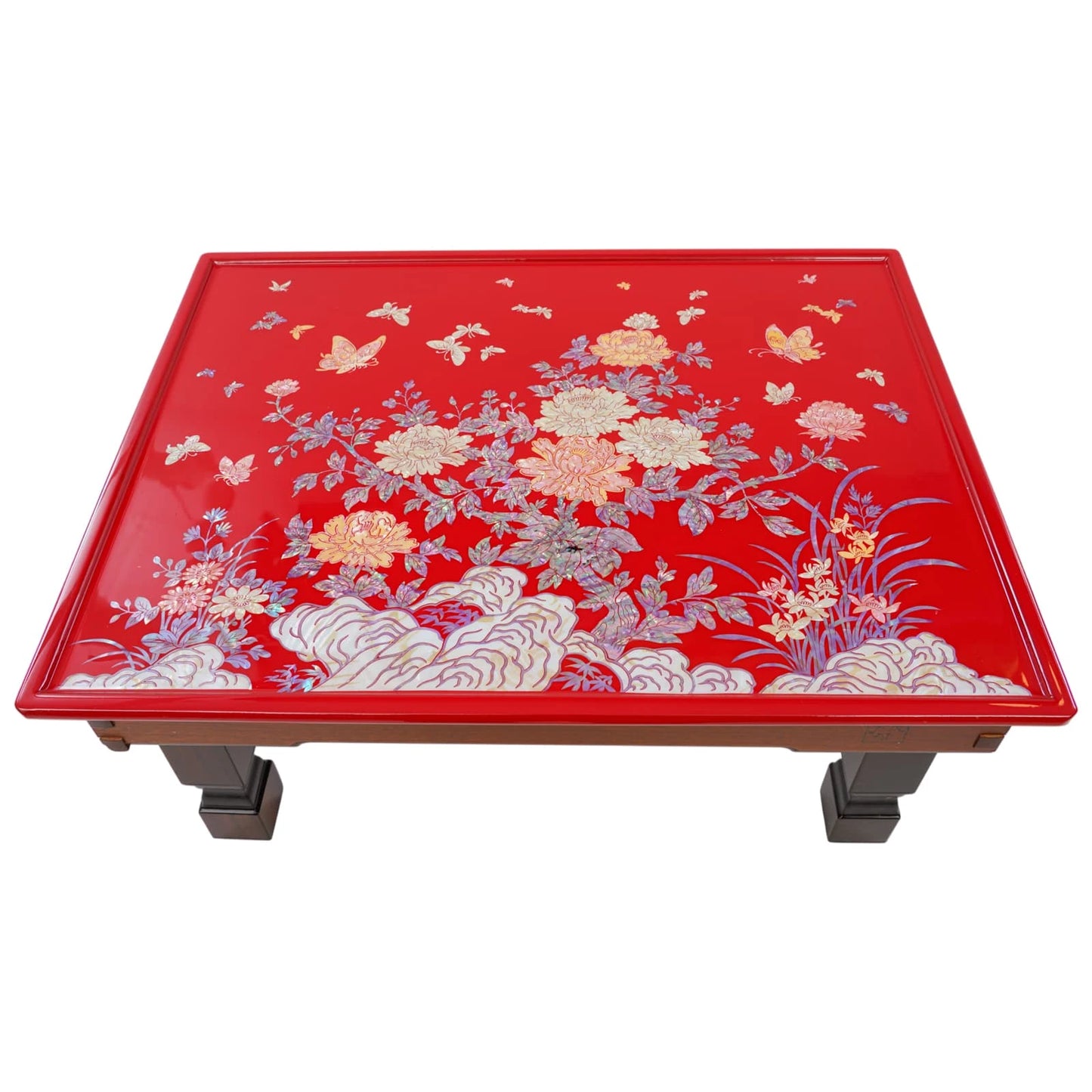 Red table with floral and butterfly design on a white background