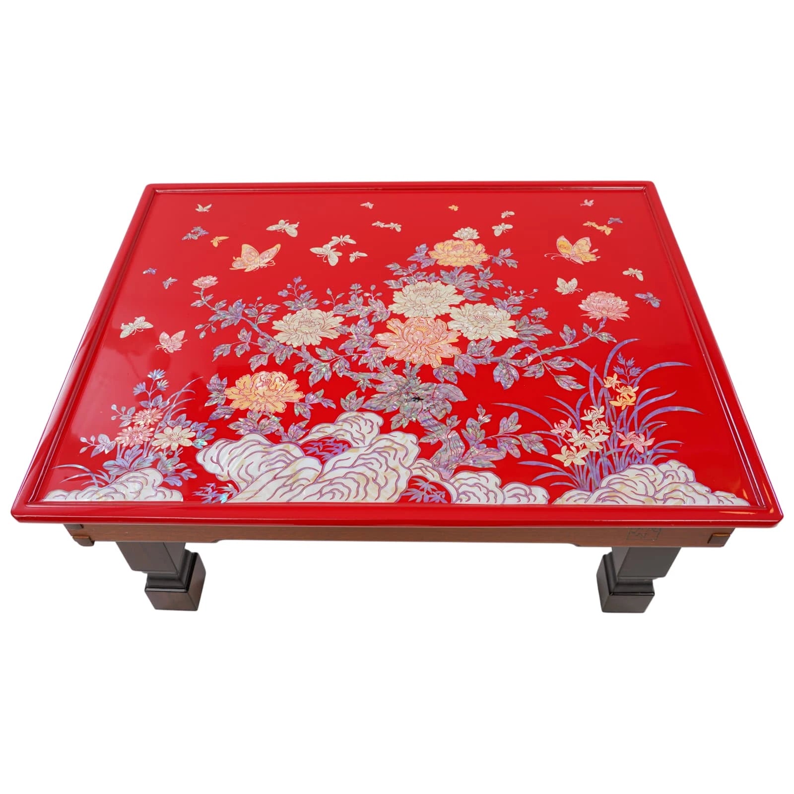 Red table with floral and butterfly design on a white background