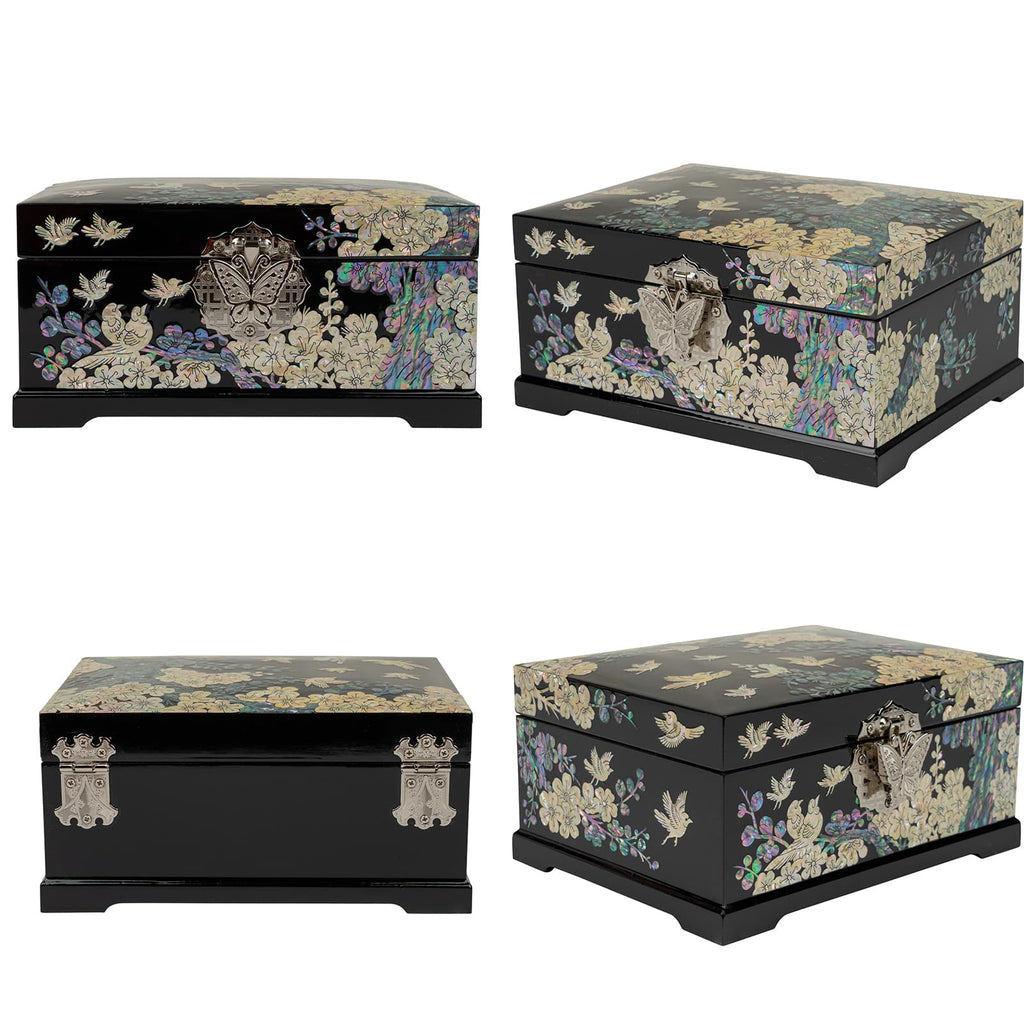 Four black lacquered boxes with floral and bird designs in mother-of-pearl inlay, each with unique metallic clasps, presented from different angles.
