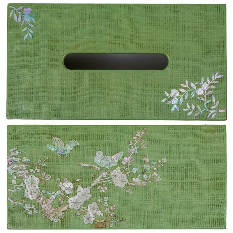 The image features a green tissue box holder with a mother-of-pearl inlay of birds and flowers on one side, and a simple branch design near the opening.