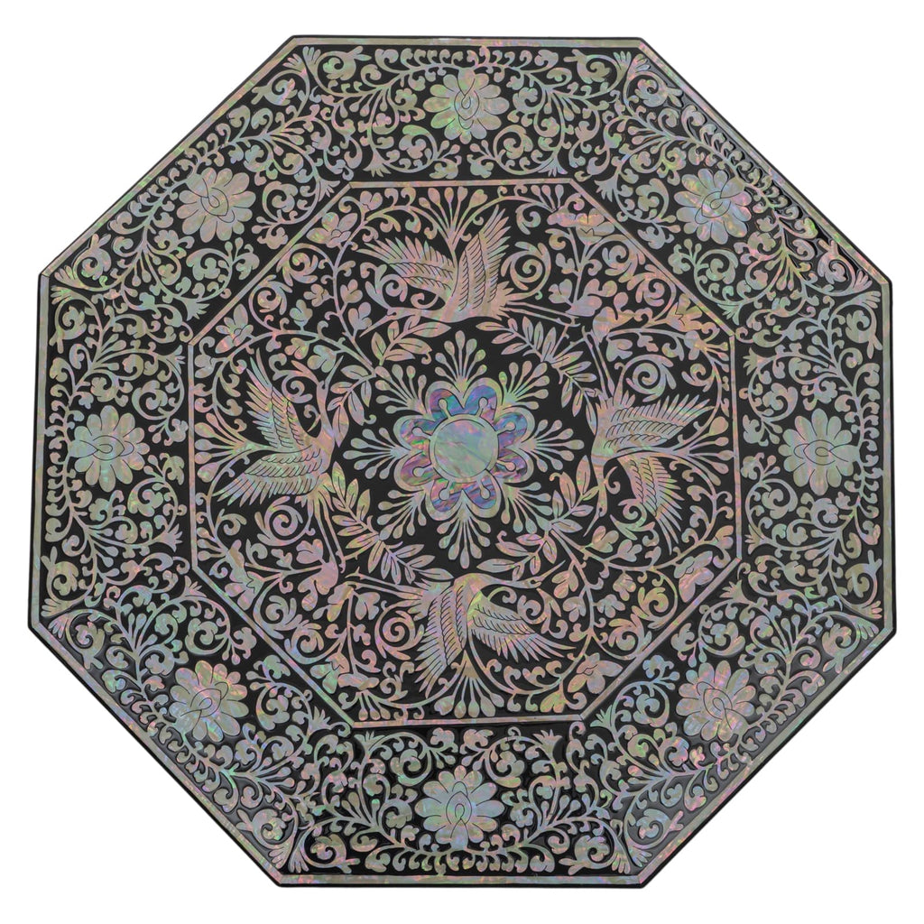 The image shows the lid of an octagonal box, intricately inlaid with Mother of Pearl in floral and avian designs, against a neutral background