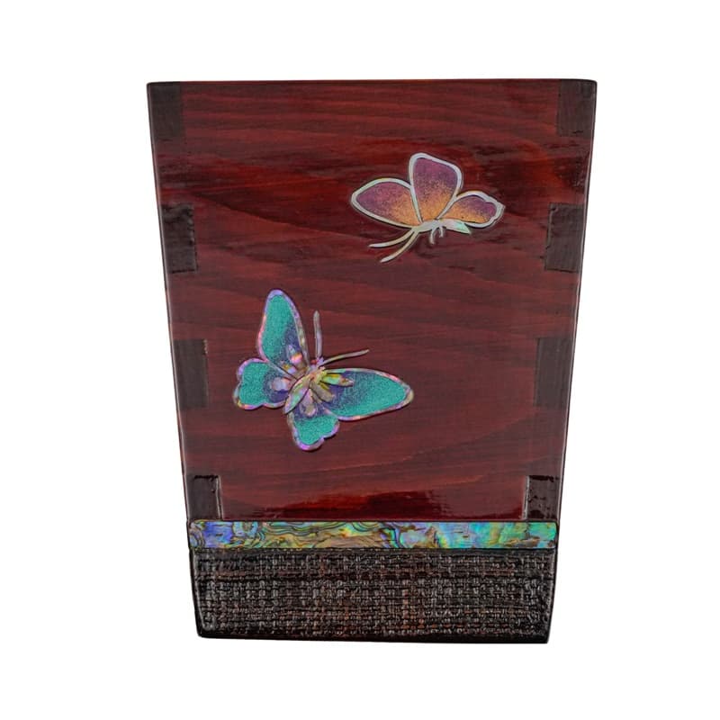 This image shows a wooden pen holder with a dark finish, adorned with a mother-of-pearl inlay of butterflies on one side.