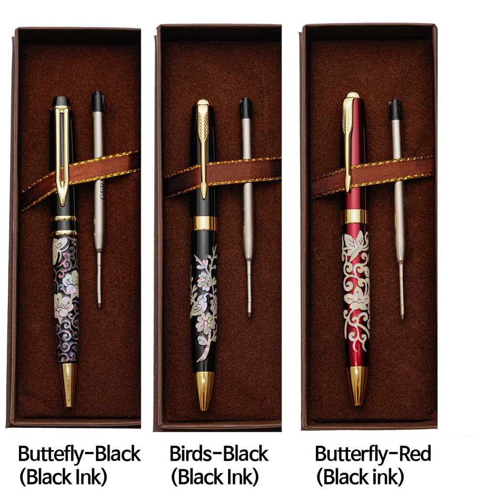 Three ballpoint pens with mother-of-pearl inlay designs (butterfly-black, birds-black, butterfly-red) are neatly arranged in their brown boxes with refills, labeled with their patterns and ink types.