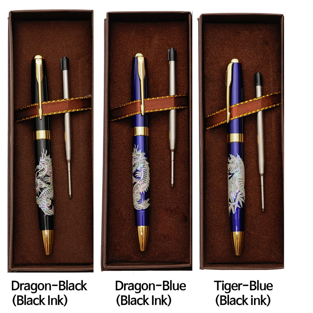 Three ballpoint pens with mother-of-pearl inlay designs (two dragons, one tiger) rest in their brown boxes with refills, labeled with their colors and ink type.