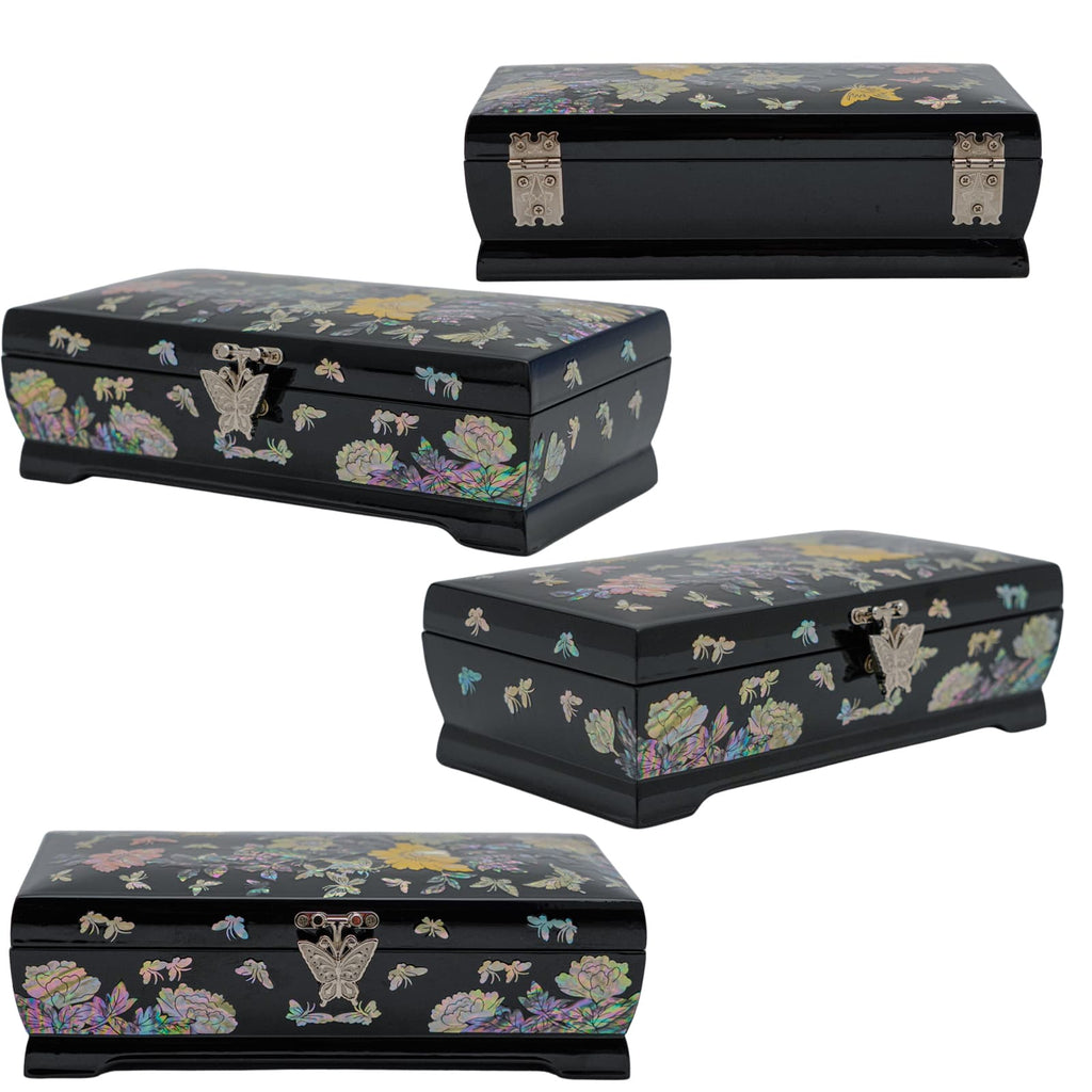 An open lacquer jewelry box with a radiant mother-of-pearl interior, the lid featuring a butterfly design, and a secure clasp in front.Three black lacquer boxes with mother-of-pearl floral inlay viewed from different angles, featuring detailed hinges and clasps.