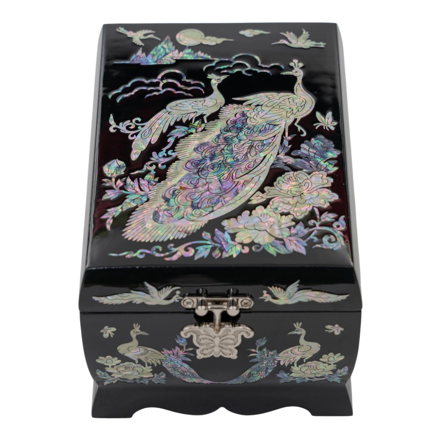 Top view of a black jewelry box showcasing a large mother-of-pearl peacock among peonies under a moon and clouds.