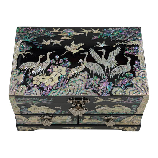 Top view of a black nacre box decorated with intricate mother of pearl inlays depicting cranes, pine trees, and moon, set against colorful floral rocks