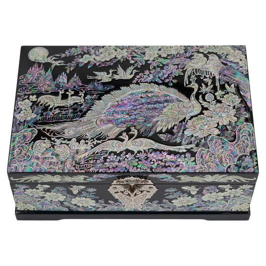 Top view of closed black wooden chest with iridescent mother of pearl peacock artwork, traditional wedding gift idea