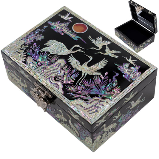 Top view of handcrafted mother of pearl jewelry box featuring crane and landscape inlay with iridescent shell detail