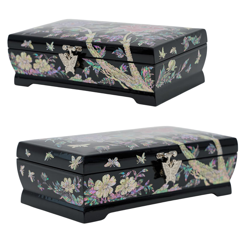 Two black lacquered jewelry boxes with detailed mother-of-pearl inlays featuring floral and butterfly motifs, each with a unique front metal clasp.