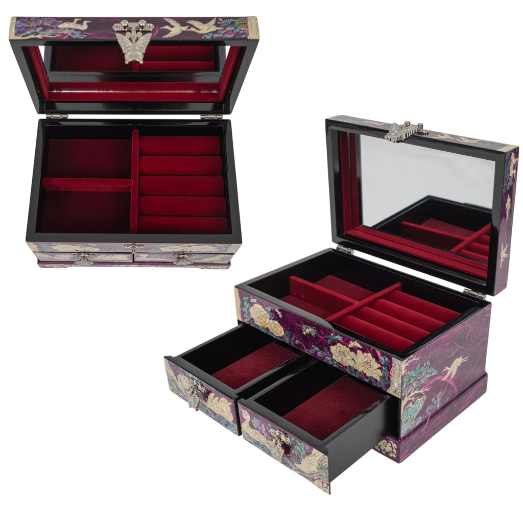 Red velvet-lined interior of jewelry box with ring rolls and open drawers