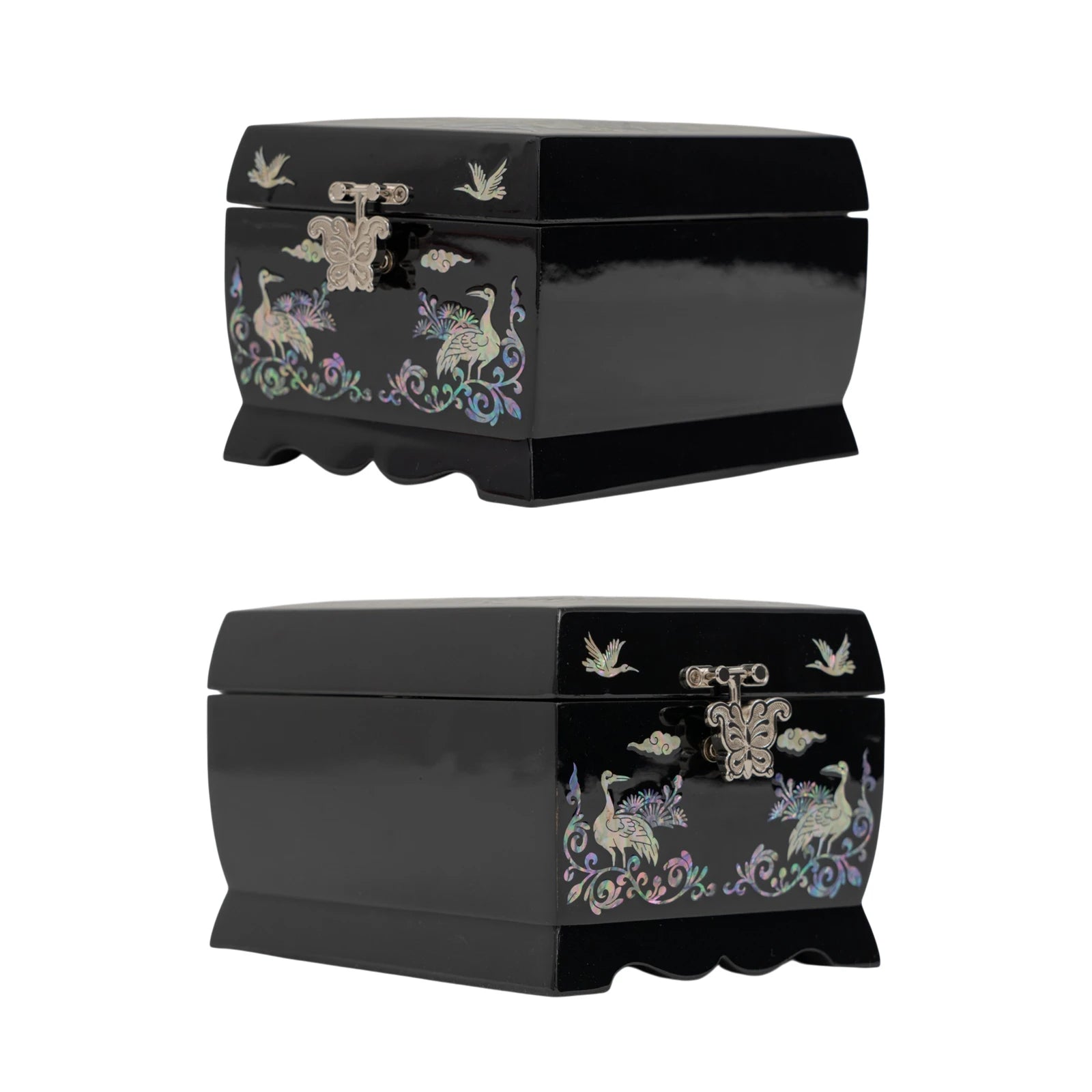 Two perspective views of a closed black lacquer box, showing the elegant curved base and mother-of-pearl crane designs on the front.