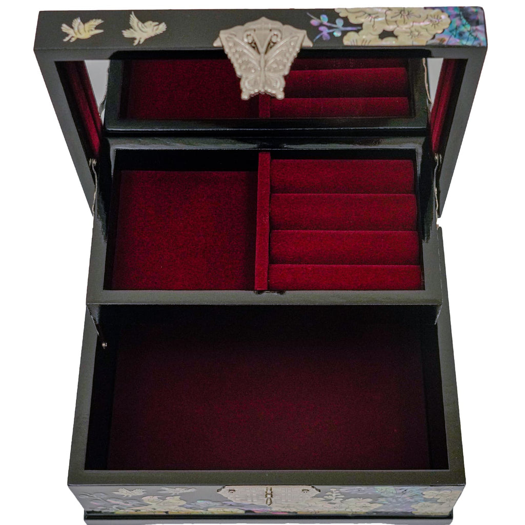 This is the interior of the decorative box showing the storage compartments. There's a larger open compartment at the bottom and a removable upper tray with smaller sections, likely for organizing jewelry or small keepsakes. The interior is lined with red velvet, and the lid features the same mother-of-pearl inlay design and butterfly clasp as the exterior.