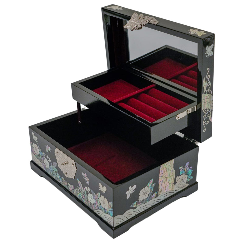 A black jewelry box with a drawer and upper compartment, both lined in red velvet. It features a floral pattern and a metal butterfly ornament.