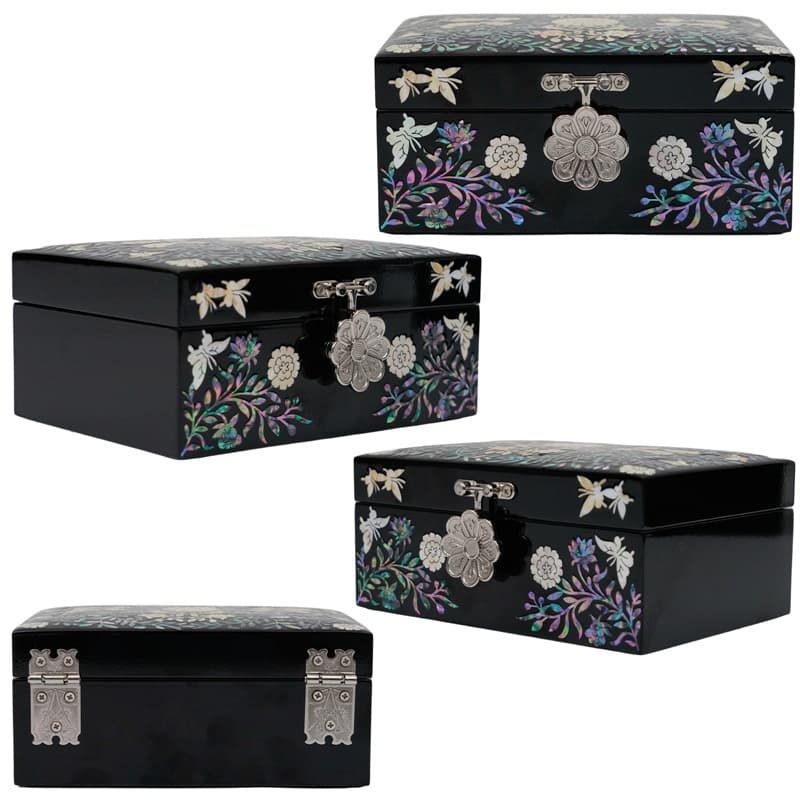Three views of a black jewelry box with floral mother-of-pearl details and different clasps on the front and sides.