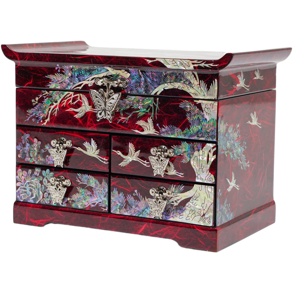  A red Korean mother-of-pearl jewelry box with crane, pine tree, and butterfly designs, featuring multiple drawers with metal handles.