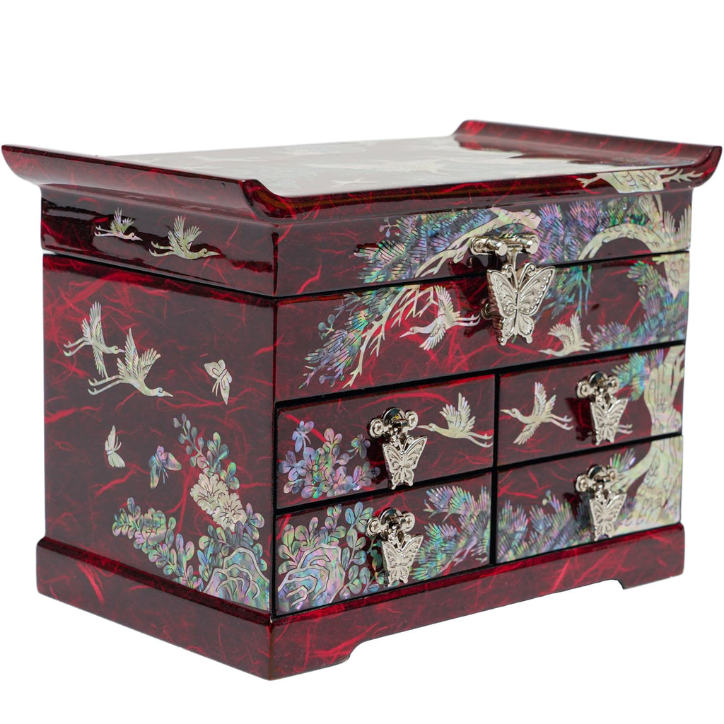 A red mother-of-pearl jewelry box with multiple drawers, featuring intricate butterfly handles and traditional Korean crane and floral designs, on a reflective surface.