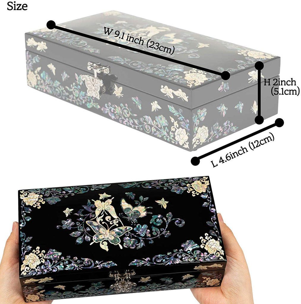 The image showcases a black jewelry box with a detailed mother-of-pearl butterfly and floral design. The box's dimensions are indicated: width 9.1 inches (23 cm), height 2 inches (5.1 cm), and length 4.6 inches (12 cm). The box is held in a hand, providing scale.