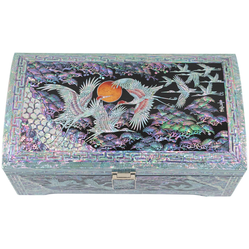 An elegant Mother of Pearl jewelry box with a Korean crane and sun design among vibrant foliage on its lid.
