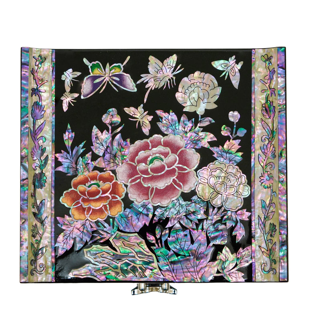 A detailed mother-of-pearl artwork featuring vibrant flowers and butterflies against a black backdrop.
